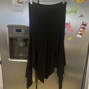 Form fitting/flares at bottom. Cut to have leg slit and asymmetrical pattern.